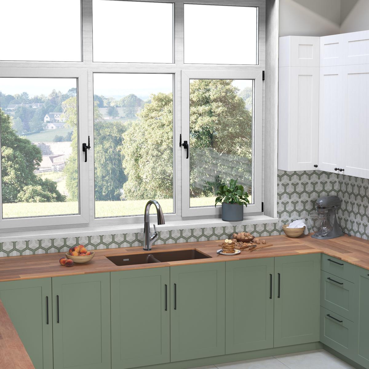 Mocha quartz double bowl undermount sink installed in green cabinetry with matching filtered faucet and wooden countertop.