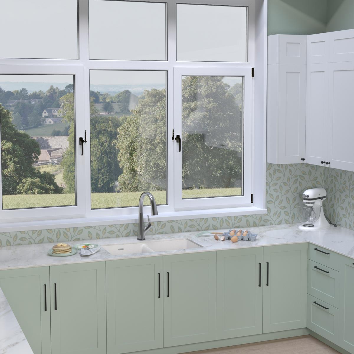 White quartz double bowl undermount sink with filtered faucet installed in green cabinetry beneath kitchen window.