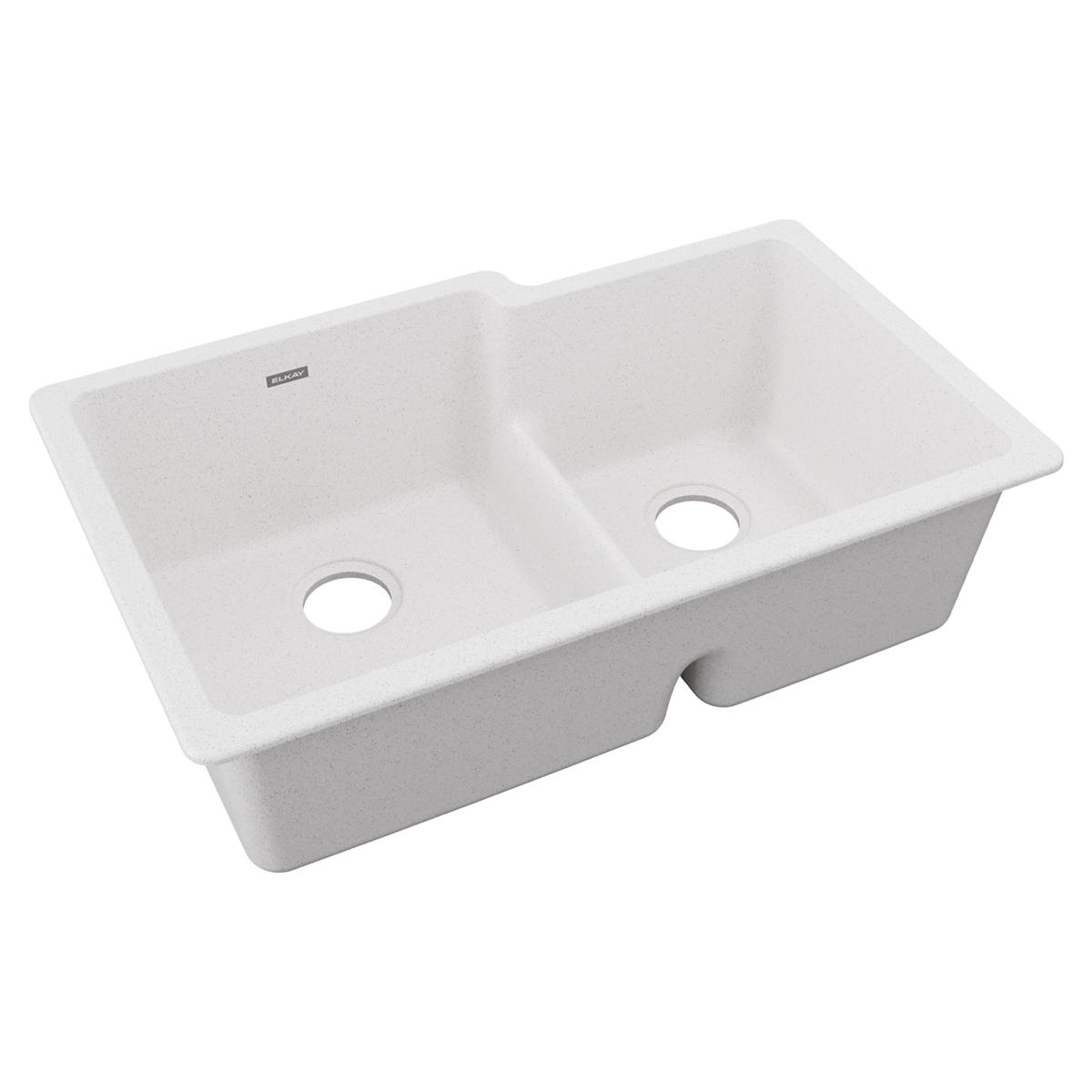 White quartz double bowl undermount sink with offset basins and drain holes.