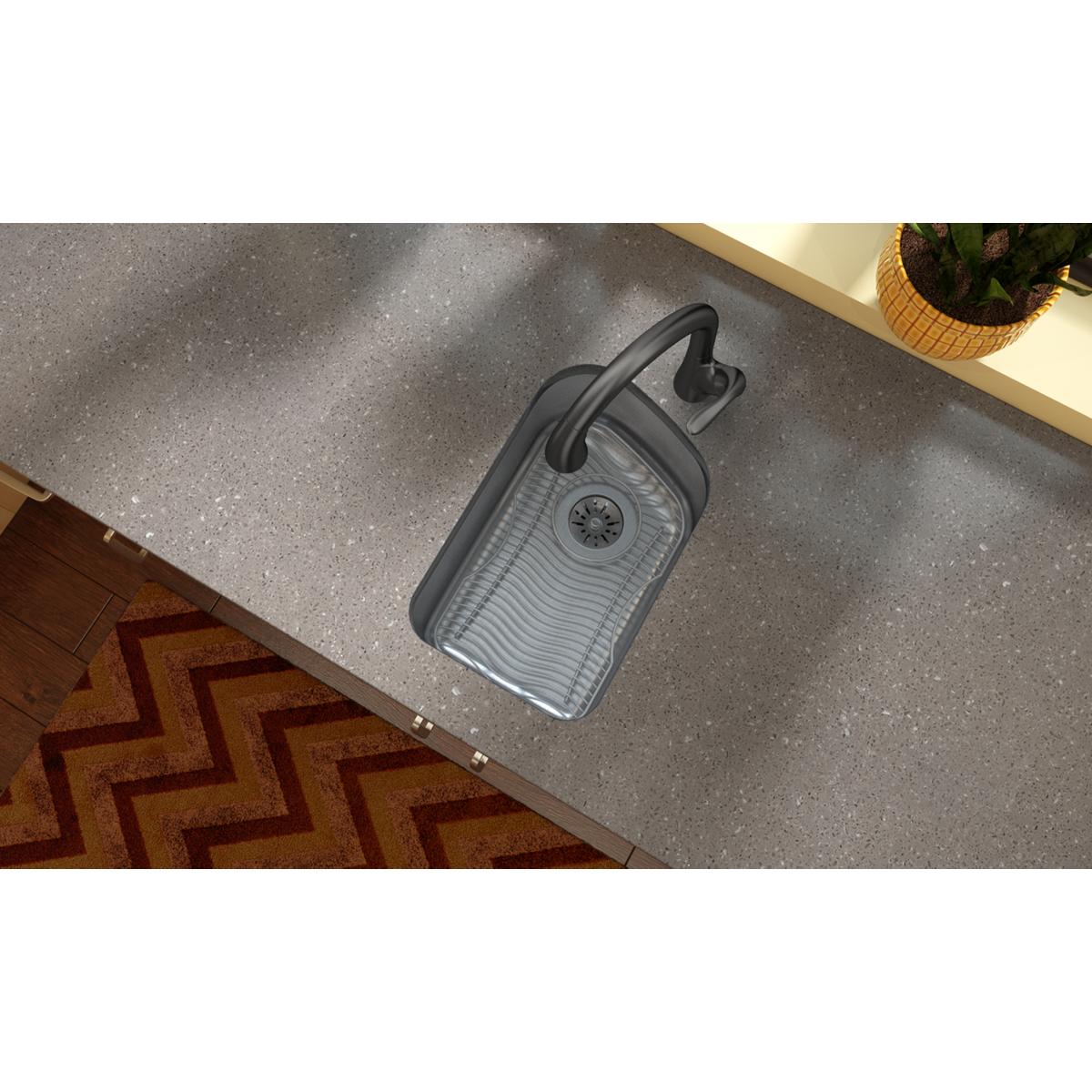 Stainless steel bottom grid with ridged surface and black handles, installed in sink basin.
