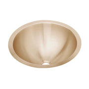 Copper undermount bathroom sink with single bowl, rounded interior, and drain hole visible.
