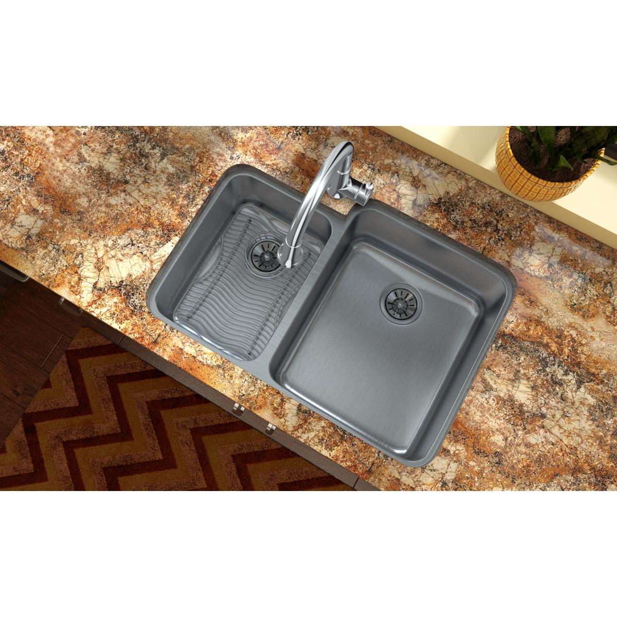 Stainless steel double bowl undermount sink with offset 40/60 configuration and faucet installed in granite countertop.