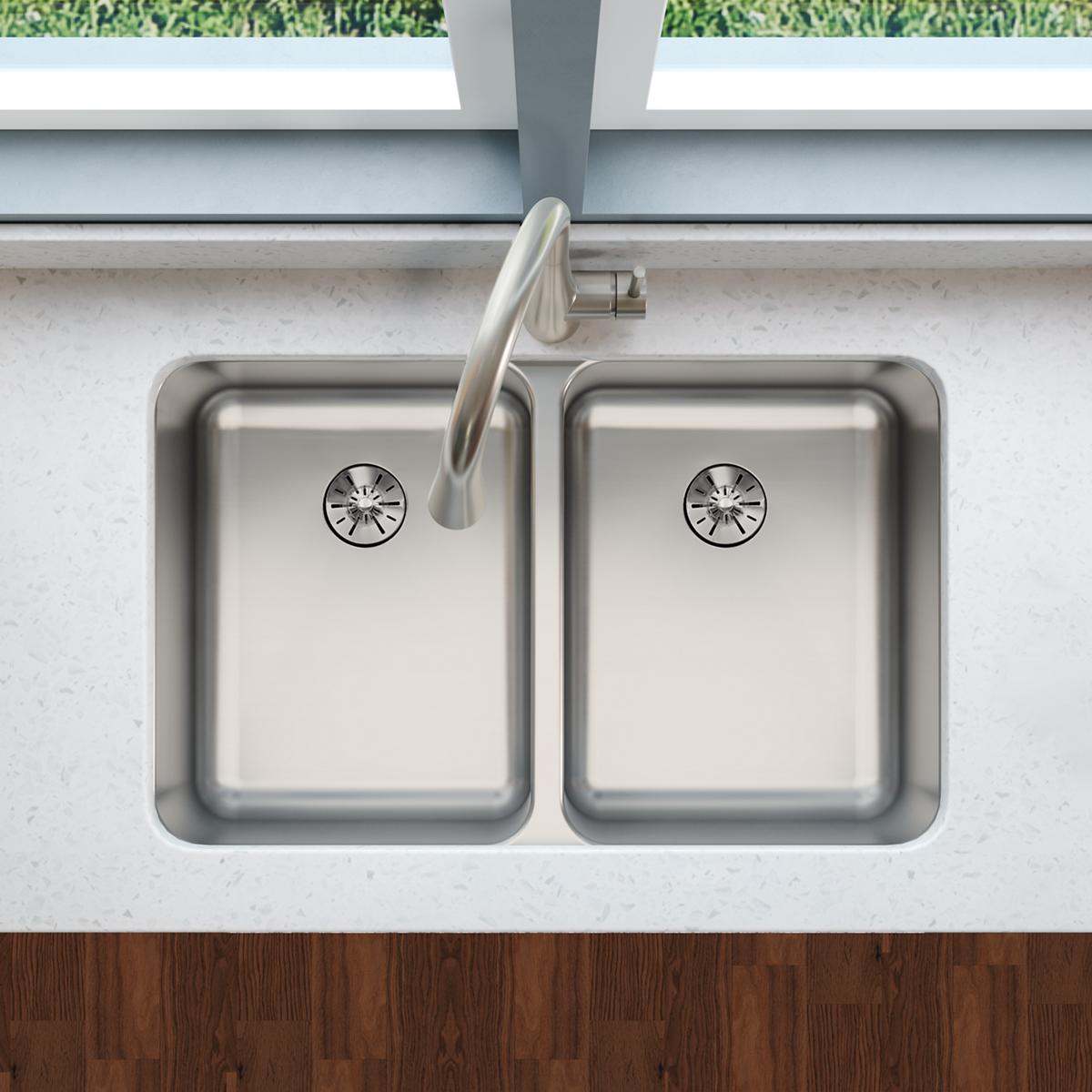 Stainless steel double bowl undermount sink with drain strainers and curved faucet, installed in white countertop.