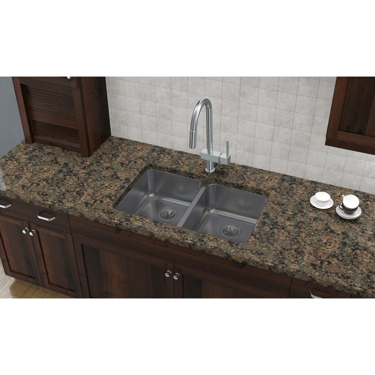 Stainless steel double bowl undermount sink installed in granite countertop with chrome faucet.