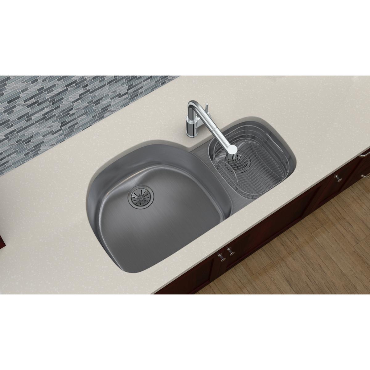 Stainless steel double bowl undermount sink with one larger and one smaller basin, installed in countertop with chrome faucet
