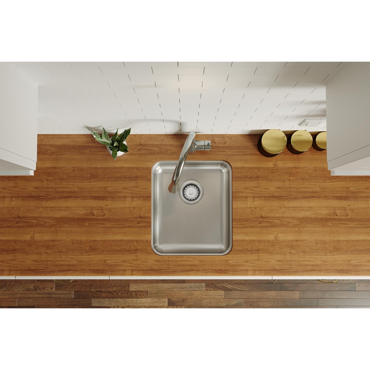 Stainless steel single bowl sink with drain strainer installed in wood countertop, viewed from above.