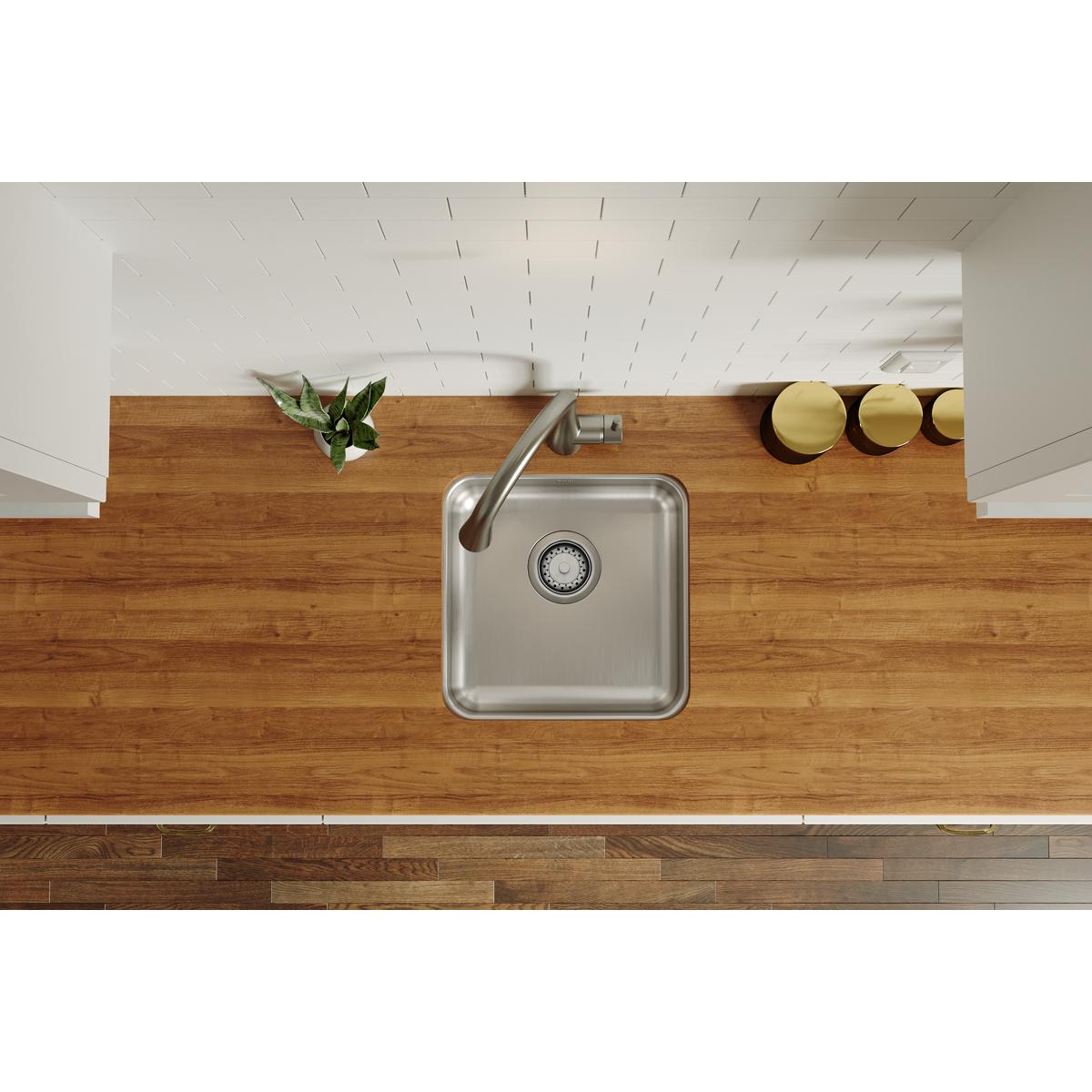 Square stainless steel undermount sink with single bowl and faucet, installed in wood countertop, overhead view.