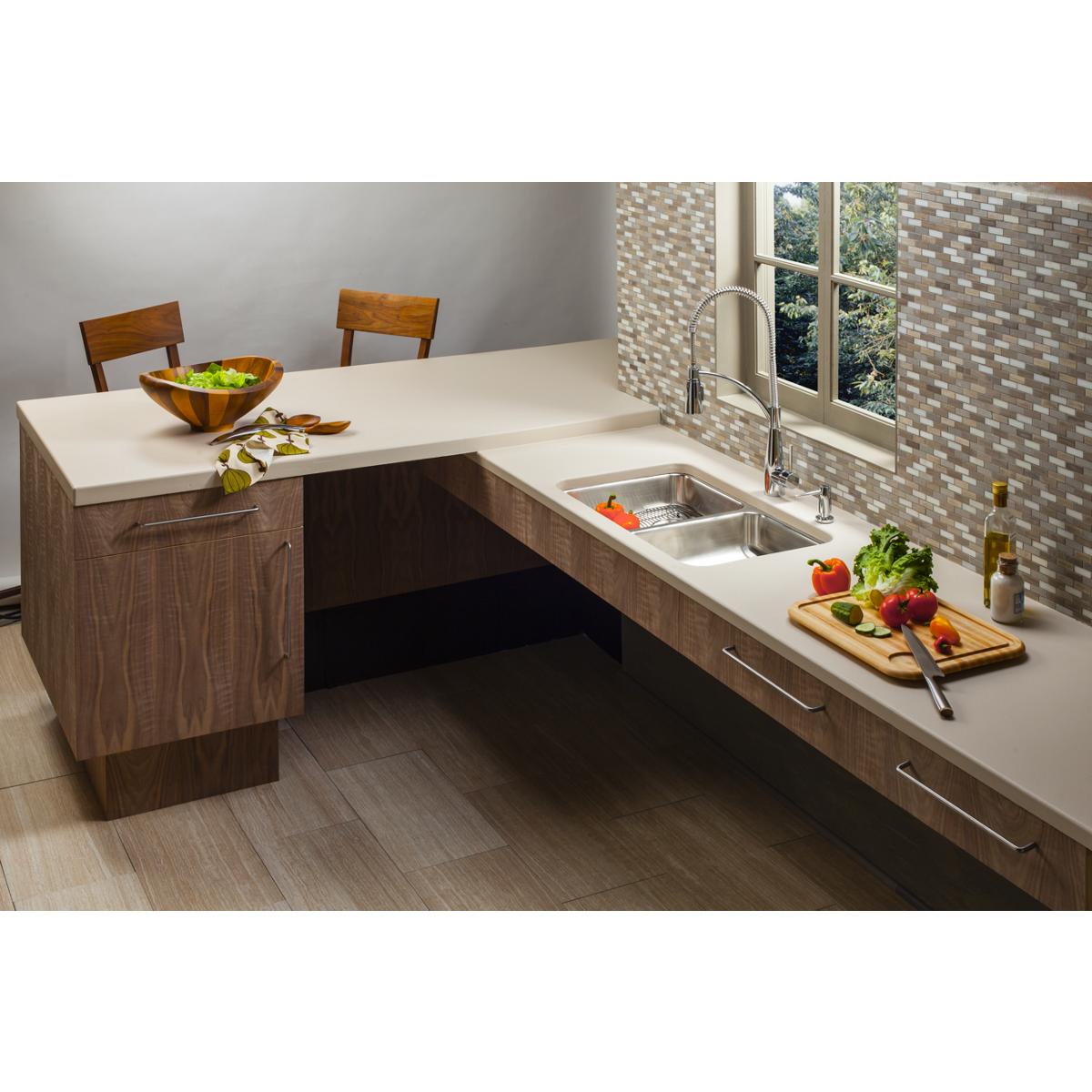 Stainless steel double bowl undermount sink installed in kitchen counter with faucet and surrounding cabinetry.
