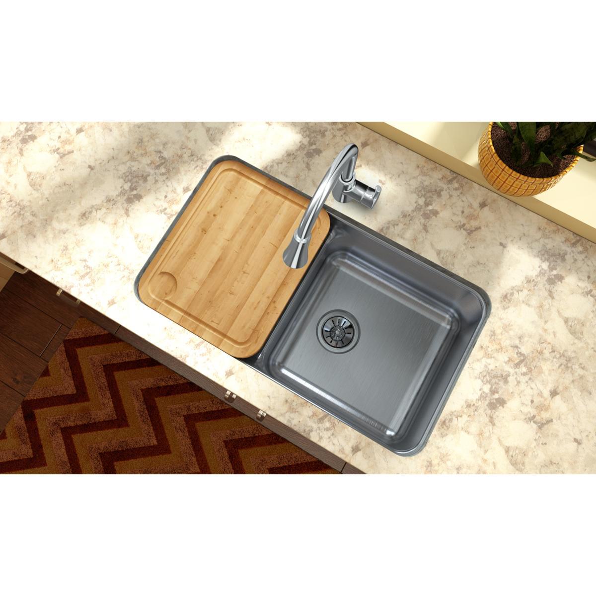 Rectangular hardwood cutting board with rounded corners and juice groove, positioned over a kitchen sink.