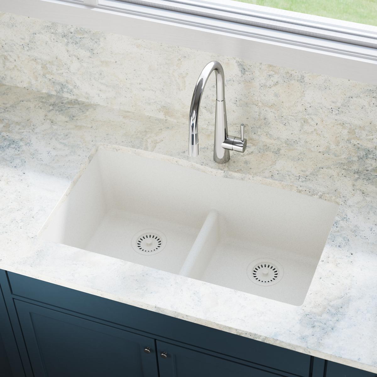 White double-basin undermount sink with chrome faucet and disposer flanges visible in basin bottoms.