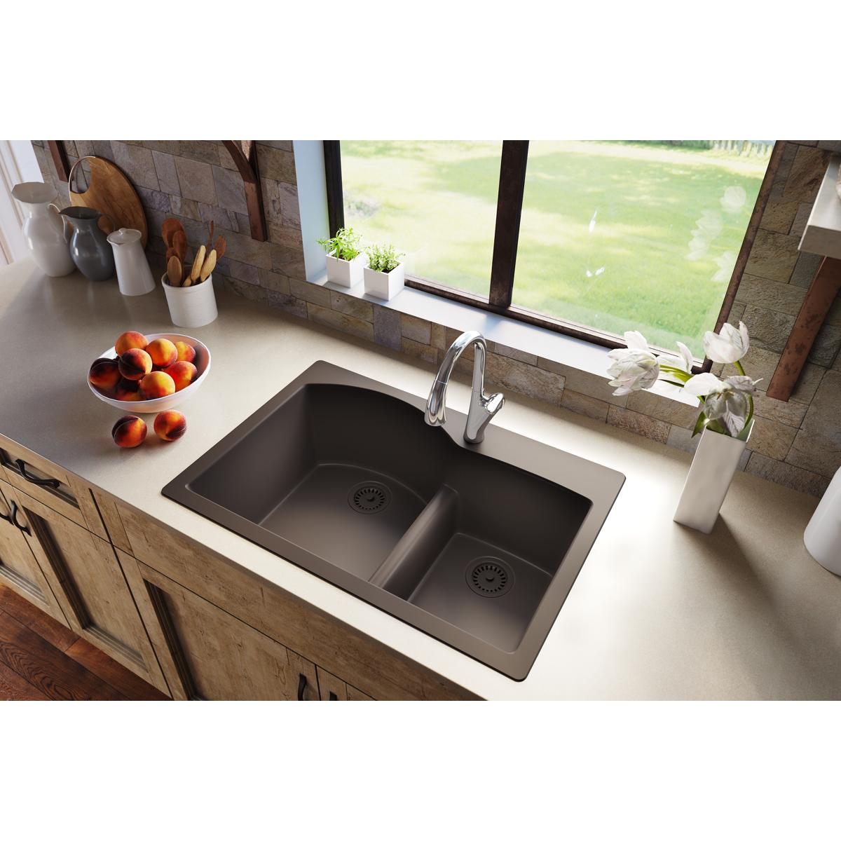 Chestnut polymer disposer flange with removable basket strainer and rubber stopper installed in double-bowl kitchen sink.