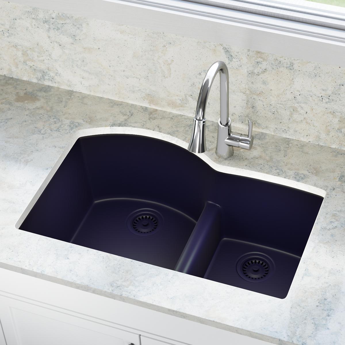 Black composite sink with two basins, each featuring a drain strainer, installed in countertop with chrome faucet.