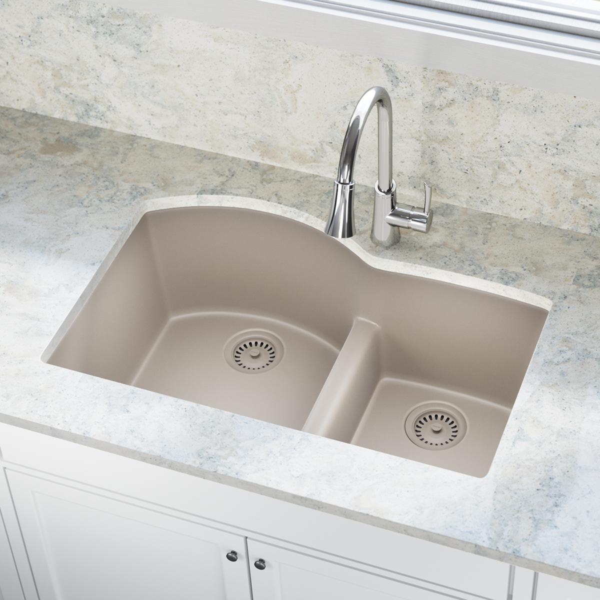 Silvermist polymer double-bowl undermount sink with two drain flanges and basket strainers installed in granite countertop.