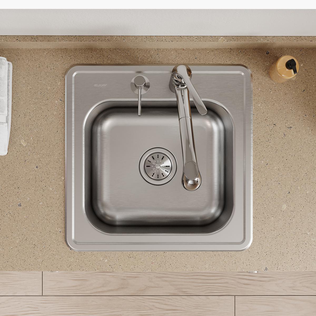 Stainless steel drop-in laundry sink with single bowl, two faucet holes, and drain basket, installed in countertop.