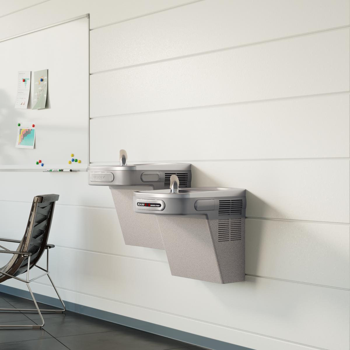 Light gray granite wall-mounted dual-level water cooler with hands-free activation mounted on white wall.
