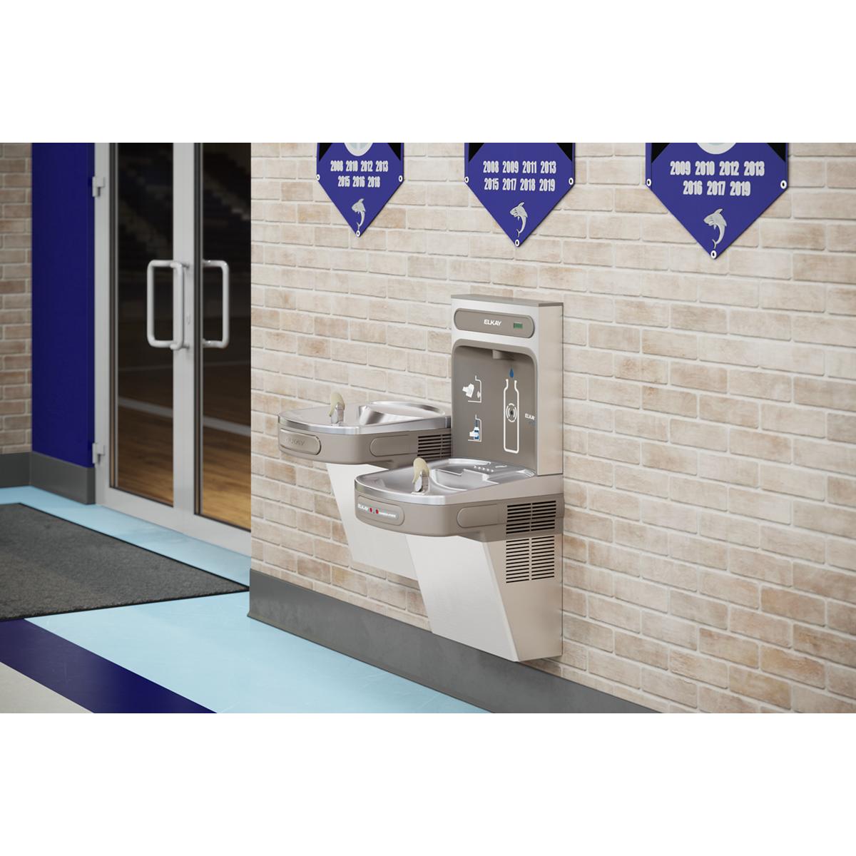 Stainless steel wall-mounted water filling station with upper and lower bottle fill spouts and hands-free activation mounted 