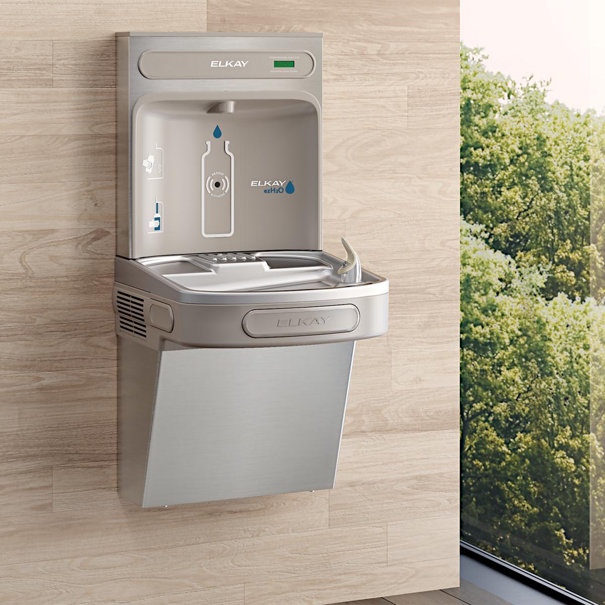 Stainless steel wall-mounted water bottle filling station with single basin and faucet, mounted on light wood wall.