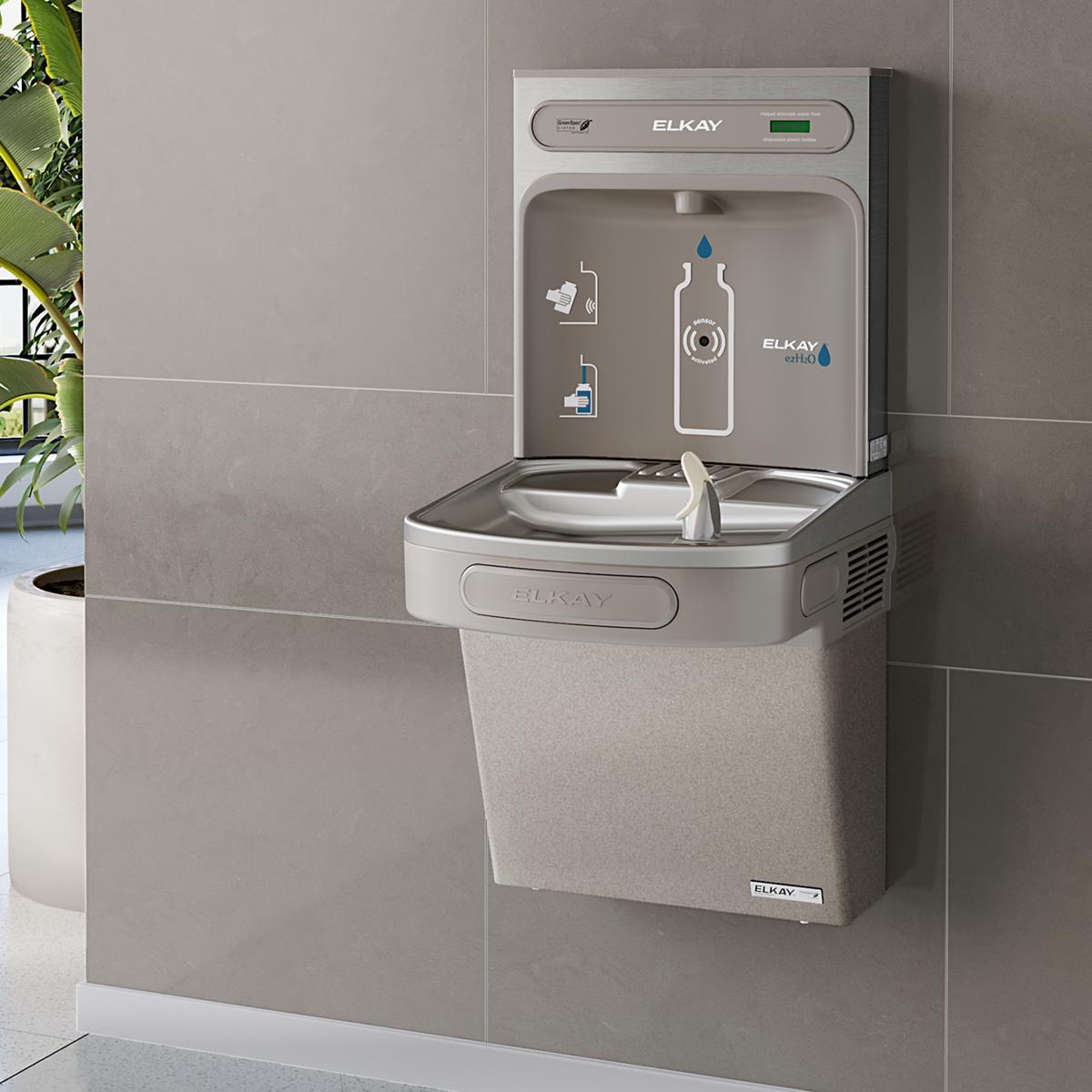 Light gray Elkay water cooler and bottle filling station mounted on wall with dual basin, digital display, and bottle graphic