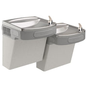 Wall-mounted dual-level water cooler with light gray granite finish and two drinking fountains with foot pedals.