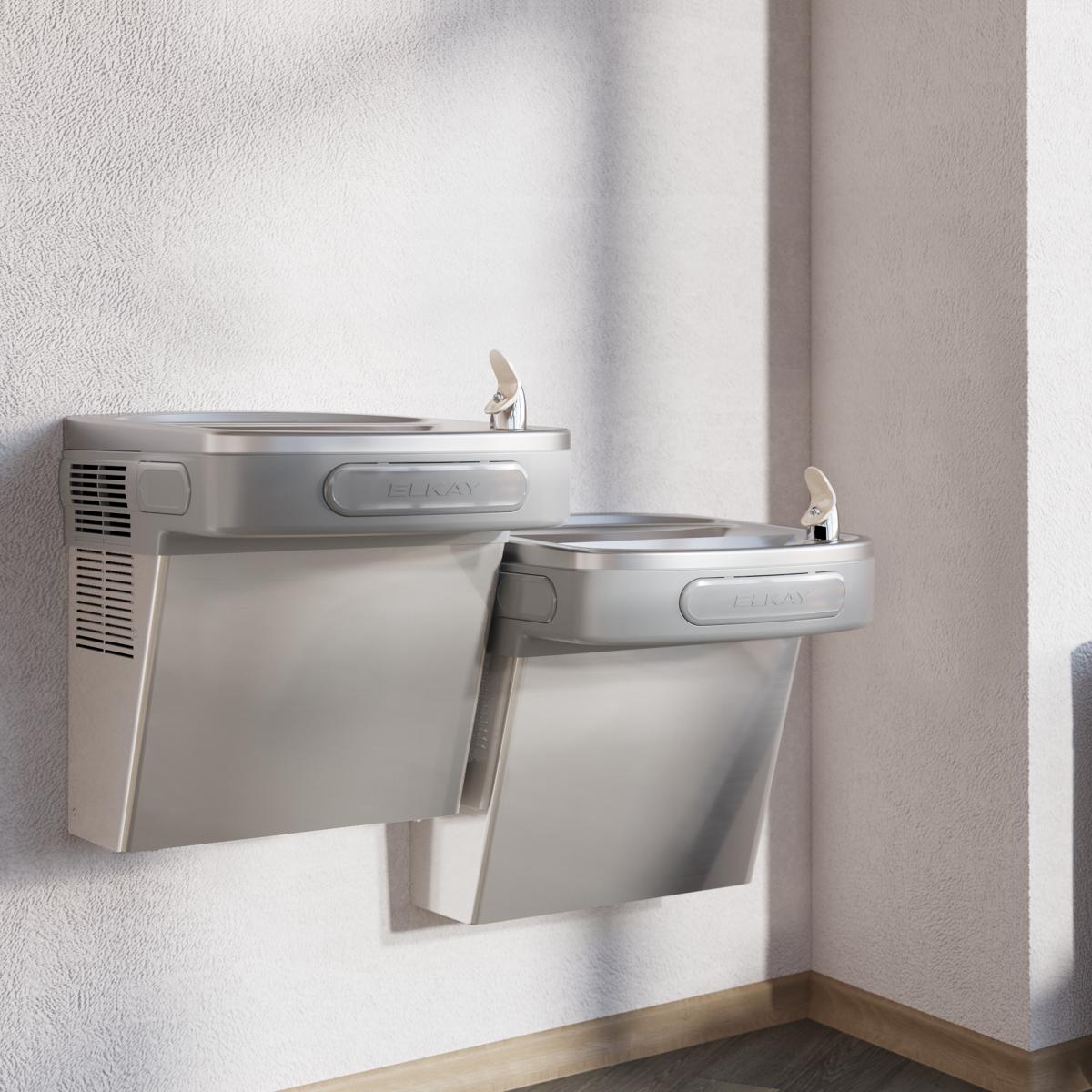 Two stainless steel wall-mounted water fountains at different heights with drinking spouts and basin areas.