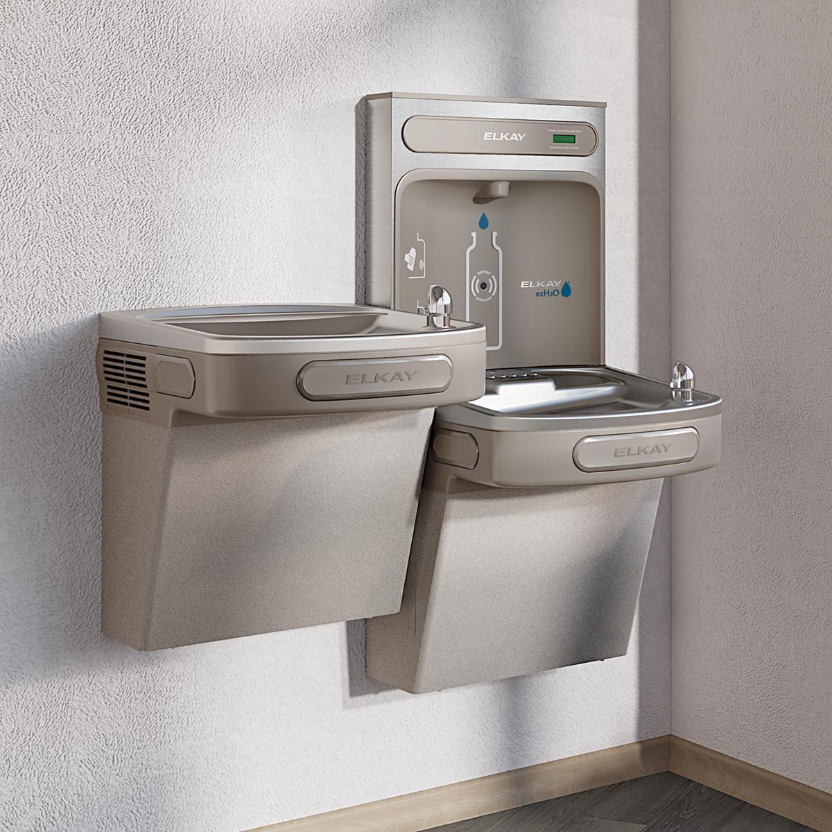 Light gray Elkay water cooler system with wall-mounted bottle filling station above two bi-level drinking fountains with meta
