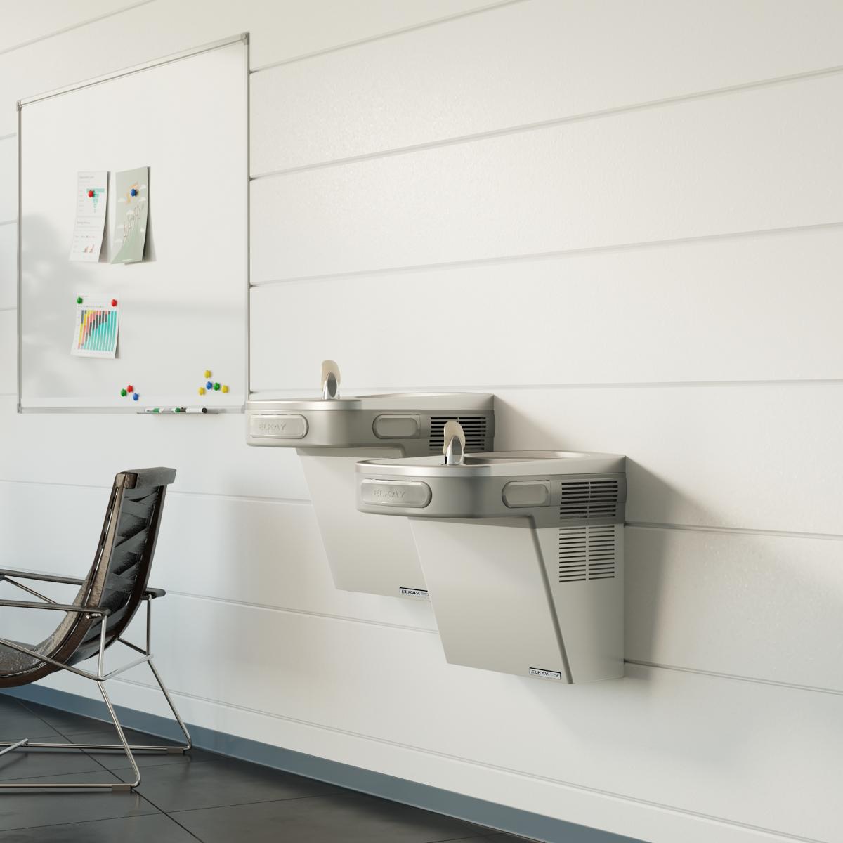 Stainless steel wall-mounted bi-level water cooler with two drinking fountains at different heights installed on white wall.