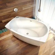 White freestanding oval bathtub with heated backrest and headrest in bathroom with wood flooring.