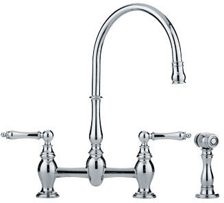 Chrome two-handle bridge faucet with high arc spout and separate side spray attachment.