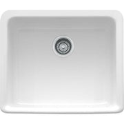 White fireclay apron front sink with single bowl and chrome drain strainer.