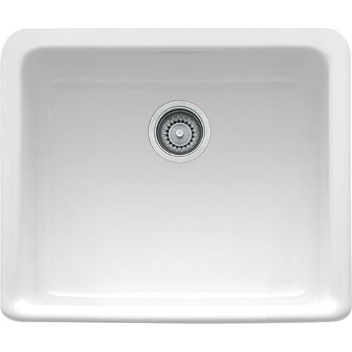 White fireclay apron front sink with single bowl and chrome drain strainer.