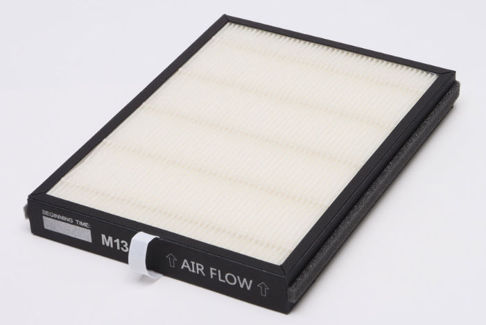 Rectangular air filter with white pleated media and black frame, showing M13 rating and airflow directional arrows on black s