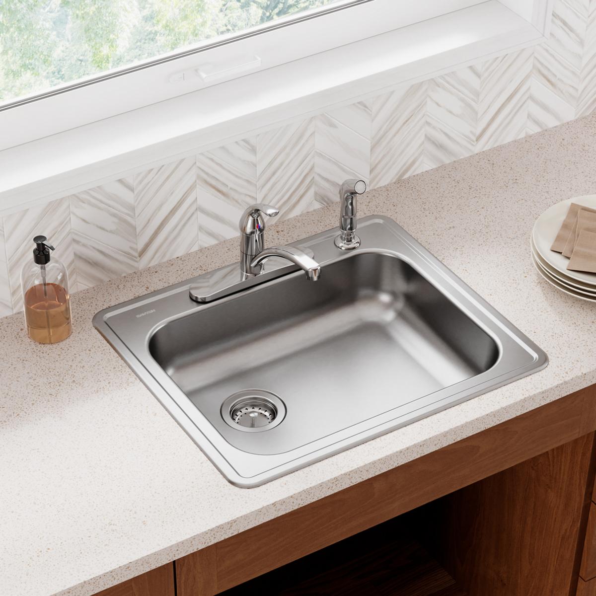 Stainless steel drop-in sink with single bowl, left drain, and four faucet holes installed in countertop.