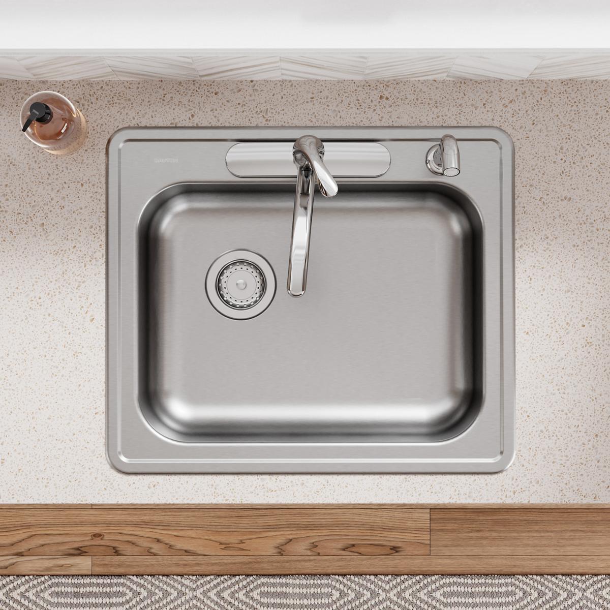 Stainless steel single bowl drop-in sink with left drain, faucet, and four mounting holes installed in countertop.