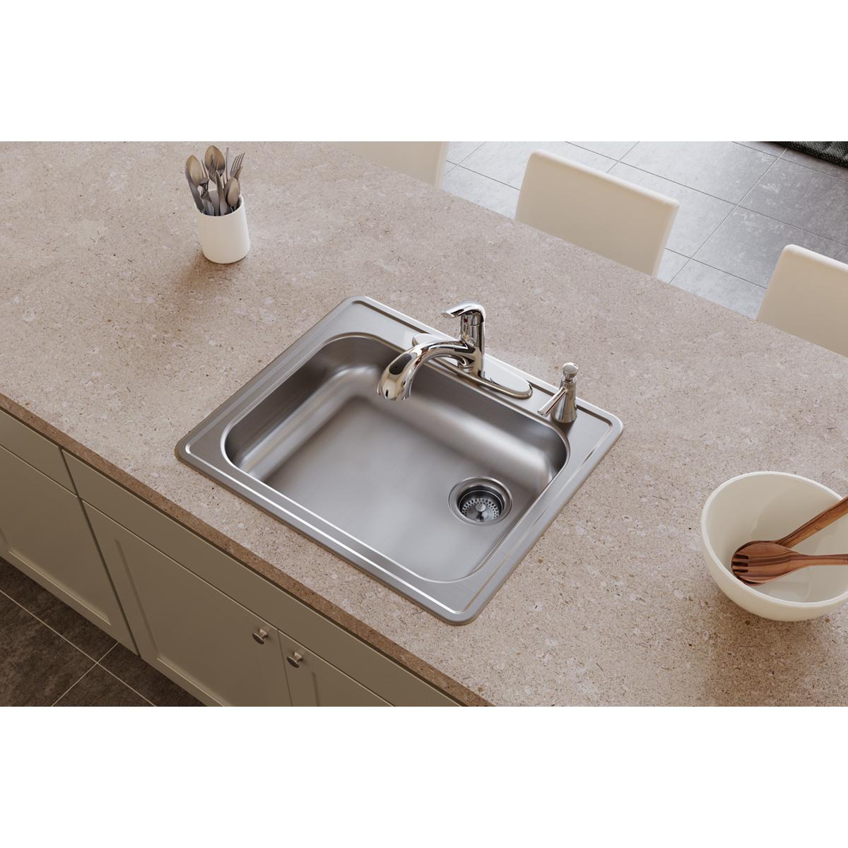 Stainless steel drop-in sink with single bowl, two faucet holes, and right-side drain installed in countertop.