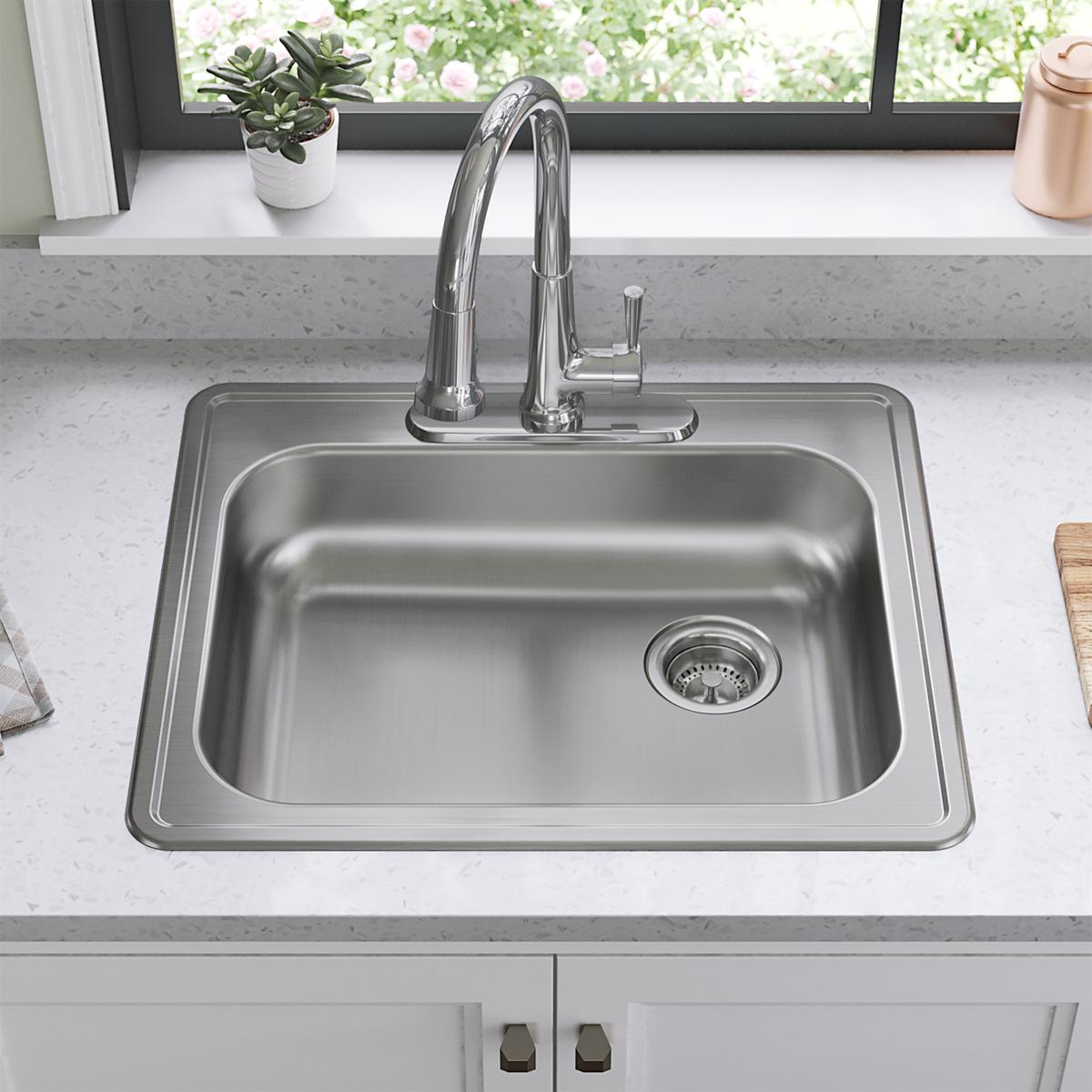 Stainless steel drop-in sink with single bowl, drain on right side, and chrome faucet installed in countertop.
