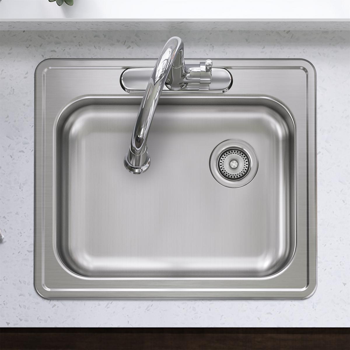 Stainless steel drop-in sink with single bowl, chrome faucet, and drain strainer positioned on right side.