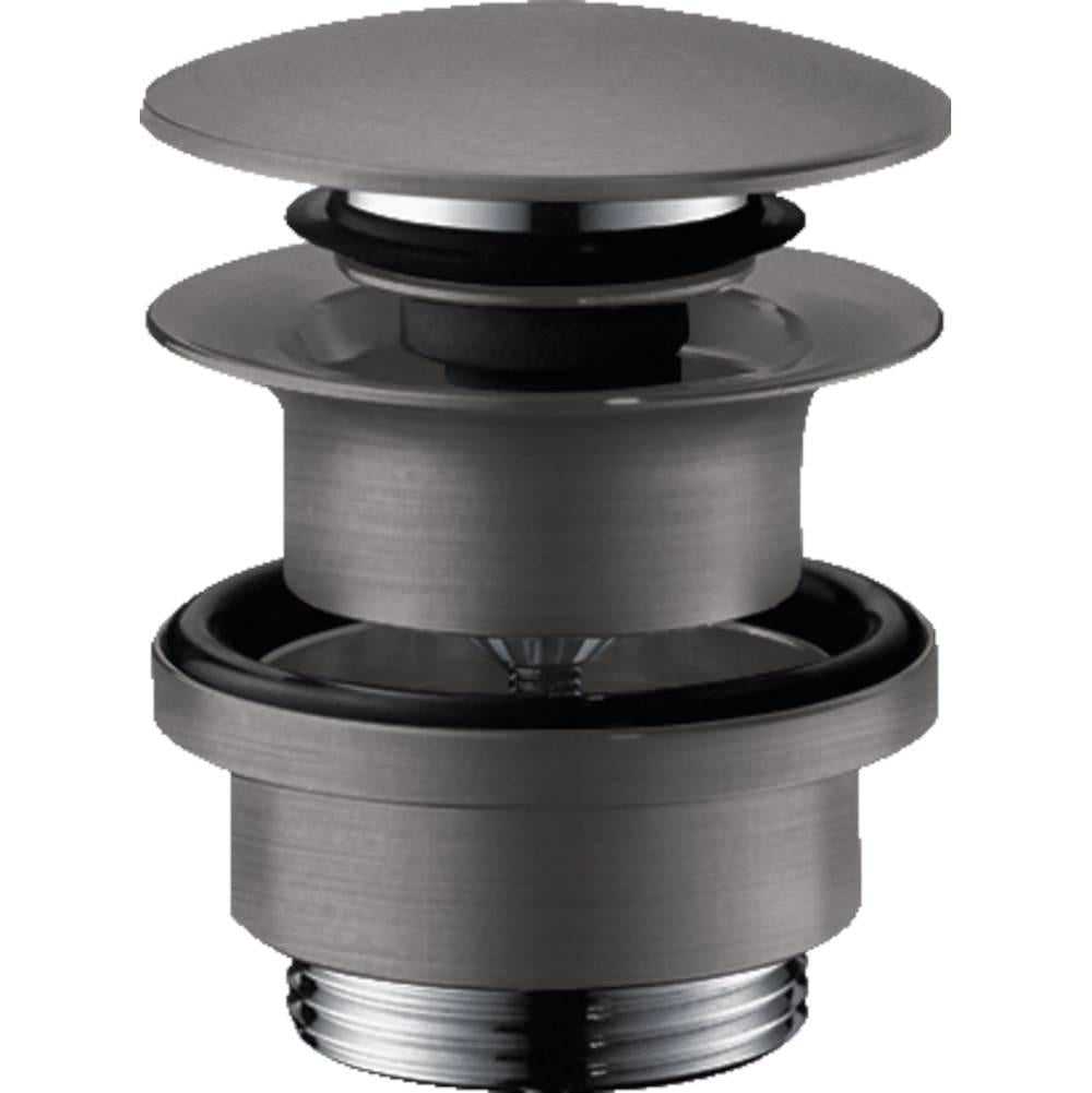 Brushed black chrome push-open sink drain with flat cap and cylindrical body, shown disassembled to display internal componen