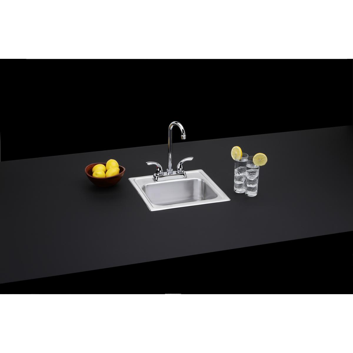 Stainless steel drop-in bar sink with chrome faucet mounted on black countertop.