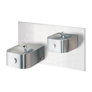 Stainless steel dual water fountains mounted on white panel with chrome faucets and circular control buttons.