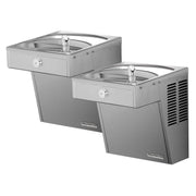 Stainless steel wall-mounted bi-level drinking fountain with two bowl stations at different heights and chrome faucets.