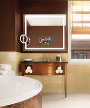 Rectangular mirror with white LED border frame and embedded TV screen displaying sports content in bathroom setting.