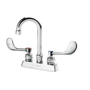 Chrome deck-mount faucet with curved gooseneck spout and two wristblade handles on white base.