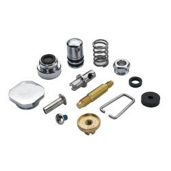 Krowne glass filler repair kit components including springs, valves, metal fittings, and gasket parts arranged on white backg