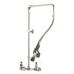 Chrome pre-rinse faucet with solid arm, green trigger spray head, and floor-mounted base.