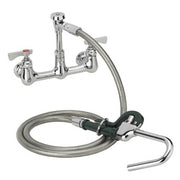 Chrome wall-mounted pot filler faucet with articulating arm and coiled hose attached.