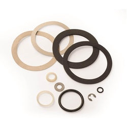 Assorted rubber gaskets and rings in tan and black, including large and small sizes for waste valve repair.