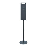 Floor stand with dark back plate and round base for liquid soap or sanitizer dispenser.