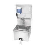 Stainless steel hand sink with knee valve, soap dispenser, and paper towel dispenser mounted above basin.