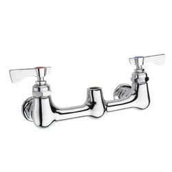 Chrome wall-mounted faucet with dual handles, curved spout, and pre-rinse spray attachment.