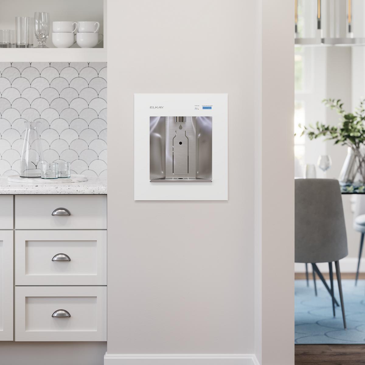 White built-in water dispenser mounted on kitchen wall with stainless steel interior and control panel.